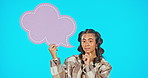 Speech bubble, thinking and idea with woman in studio for feedback, social media and mockup. Review, promotion and icon with portrait of female on blue background for opinion, communication and sign