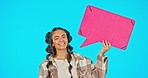 Speech bubble, face and social media with woman, advertising and smile with mockup on blue background. Voice, opinion and product place with branding and happy young female in portrait in studio
