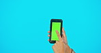 Woman hand, green screen and phone in studio advertising website, mobile app or network connection. Hands of gen z female model with smartphone for brand, social media or logo product placement