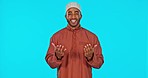 Portrait, muslim or man in studio praying isolated on blue background to worship God or Allah in praise. Smile, Islam or happy spiritual person in prayer with faith, mindfulness or gratitude of peace