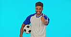 Soccer ball, man smile and thumbs up in studio isolated on a blue background mockup. Face portrait, football sports and happy Indian person with emoji or hand gesture for agreement, like or header.