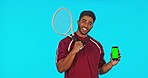 Phone, tennis and man laughing with green screen in studio isolated on a blue background. Face portrait, racket sports and funny person with cellphone for advertising, mockup or product placement.
