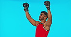 Boxer, man and celebration, winner or champion in studio isolated on a blue background mockup. Athlete, boxing sports and happy Indian person celebrate success, achievement or winning competition.