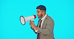 Speaker, loud and businessman shouting on a megaphone making an announcement isolated in a blue studio background. Frustration, audio and screaming man speaking on a voice broadcast or speech