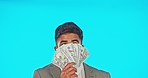Thinking, looking and a businessman holding money isolated on a blue background in a studio. Plan, success and a corporate guy with bonus cash, lottery jackpot or wealthy from work in finance