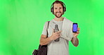 Fitness, mockup and green screen with man and phone for music, streaming and website. Digital, technology and pointing with male athlete on studio background for sports app, internet and social media