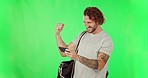 Man, winner and phone to celebrate on green screen with fist and laughing for game or competition. Excited male with smartphone happy about success or winning notification for bonus, yes or progress