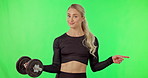 Fitness, dumbbell and woman on green screen and pointing finger at space or gym mockup. Portrait of athlete person exercise or workout for strong muscle or wellness offer, promotion or discount
