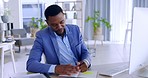 Black man, computer and writing in book for finance, budget or corporate planning at office. African American businessman typing on desktop PC and taking notes for financial project plan at workplace