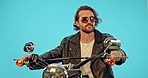 Motorbike, studio and man with a sunglasses on a ride adventure with wind in hair and confidence. Male model, isolated and blue background of a cool person on motorcycle on a road trip journey