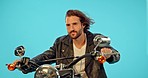 Motorbike, freedom and man in studio on blue background for road trip, adventure and leather aesthetic. Driving, motorcycle and man riding on mockup, edgy and confident, vintage and retro isolated