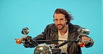 Motorbike, driver and man in studio on blue background for road trip, adventure and leather aesthetic. Driving, motorcycle and man riding on mockup, edgy and confident, vintage and retro isolated