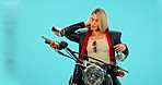 Sport, jacket and motorcycle with woman in studio for vintage, retro or transportation. Urban, leather and fashion with biker riding on motorbike on blue background for travel and attitude