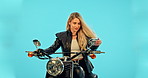 Riding moterbike, road trip and a woman thinking on a drive isolated on a blue background in a studio. Freedom, driver and a female biker on a motorcycle for transportation, adventure and travel