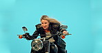 Sport, fast and motorcycle with woman in studio for vintage, retro or transportation. Urban, leather and fashion with biker riding on motorbike and isolated on blue background for travel and attitude