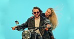 Travel, blue background and couple on motorcycle for adventure, road trip and holiday mockup. Motorbike, transport and man and woman ride together for weekend, vacation and trip with wind in studio