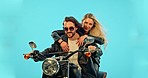 Travel, blue background and couple on motorcycle for road trip, adventure and holiday mockup. Motorbike, transport and man and woman ride together for weekend, vacation and trip with wind in studio