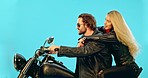 Travel, blue background and couple on motorcycle for adventure, road trip and holiday mockup. Motorbike, transport and man and woman ride together for weekend, vacation and trip with wind in studio