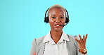 Call center, headset and face of woman talk for customer support, sales or help in studio. Black female agent or consultant working for crm, telemarketing and advice or help on blue background  
