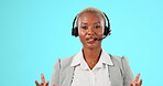 Call center, headphones and face of woman talking for customer support, sales or help in studio. Black female agent or consultant working as crm, telemarketing and advice or help on blue background  