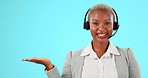 Hand, headset and call center woman talking for customer support, sales or product in studio. Black female agent or consultant working for telemarketing and advertising mockup on blue background  