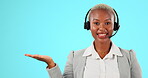 Call center, hand space and portrait of woman talking for customer service or sales in studio. Black female agent or consultant working in telemarketing and advertising mockup on blue background  