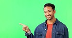 Smile, face and man hand pointing to green screen studio for commercial promotion, advertising and mockup. Portrait, happy and asian male showing space, product placement and isolated copy space