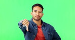 Face, thumbs down and man on green screen in studio isolated on background. Portrait, hand gesture and serious person with emoji for dislike, negative opinion or rejection, failure or wrong vote.