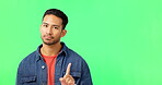 Portrait, hand gesture and no with a man on a green screen background in studio waving his finger. Stop, warning and negative with a young person in disagreement or conflict on chromakey mockup
