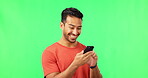 Happy, smile and phone with asian man on green screen for social media, technology or website. Internet, app and online news with male and text message on studio background for search, mobile or chat
