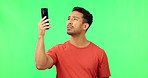 Bad, signal and man with phone in green screen studio with problem, internet and delay on mockup background. Smartphone, issue and confused mexican guy annoyed with 404, glitch or poor connection