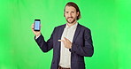 Businessman, phone and mockup on green screen with tracking markers against studio background. Portrait of man pointing to mobile smartphone display in business advertising or marketing on copy space