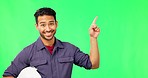 Asian man, engineer and pointing on green screen for advertising or marketing against a studio background. Portrait of happy male contractor showing gesture or point to product placement on mockup
