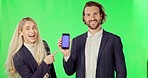 Business people, pointing and phone on green screen with tracking markers against studio background. Portrait of businessman and woman with smartphone display for advertising or marketing on mockup