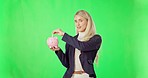 Business woman, money and piggy bank on green screen for investment, budget or finance against studio background. Female holding cash for profit, investing or financial freedom and savings on mockup