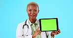 Doctor face, tablet and green screen isolated on studio background telehealth, medical or medical presentation. Healthcare professional or black woman advice, show digital technology and mockup space