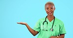 Doctor hand, empty space and presentation isolated on blue background for healthcare mockup or product placement. Face of black woman, surgeon or nurse with medical advice, palm or studio advertising