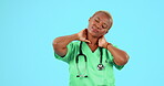 Neck pain, nurse and black woman with injury isolated on a blue background mockup in studio. Arthritis, burnout and female medical professional with fatigue, fibromyalgia or sick with spine problem.