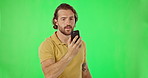 Phone call, talking and man on green screen in studio isolated on a mockup background. Feedback, conversation and person frustrated or struggling with network or speaking with contact on mobile