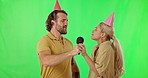 Green screen, birthday and friends singing karaoke for a birthday celebration isolated in a studio background. Microphone, song and people sing to celebrate together and feeling happy making music