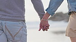 Back, holding hands and a couple at the beach for walking, freedom and bonding with love. Commitment, together and a man and woman on a walk at the ocean with affection, care and support on a date