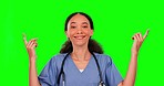 Nurse, green screen and woman pointing up to mockup in studio isolated on a background. Medical professional, product placement and happy person with face portrait, advertising and marketing space.
