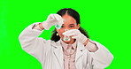 Science, pouring and a woman mixing on a green screen background in studio for chemical safety. Smile, experiment and reaction with a happy female scientist testing a solution on chromakey mockup