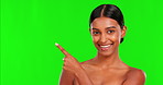 Beauty, skincare and a woman pointing on a green screen background in studio for natural care. Portrait, skin or antiaging treatment with a happy young female model advertising on chromakey mockup