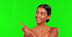 Beauty, choice and a woman pointing on a green screen background in studio for natural skincare. Portrait, select or antiaging treatment with a happy young female model marketing on chromakey mockup