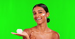 Beauty, cream and thumbs up with a woman on a green screen background in studio for natural skincare. Portrait, lotion and motivation with a happy young female model advertising on chromakey mockup