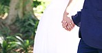 Wedding, marriage and man and woman holding hands in park for ceremony, commitment and celebration in nature. Relationship, partnership and bride and groom couple outdoors for romance, trust and love