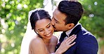 Wedding, couple and laughing in park, kiss and support of celebration, bridal union and marriage event. Happy bride, groom and smile in garden for love, hug and celebrate commitment together outdoor