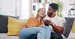 Couple, phone and relax on sofa with social network app, blog or video with communication in home. Man, woman and smartphone on couch with hug, conversation or reading with love, web chat or internet