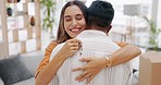 Happy woman hugging man in new home, keys and moving in to real estate, investment and apartment. Excited young couple hug to celebrate key to building property, residential house and mortgage loan 